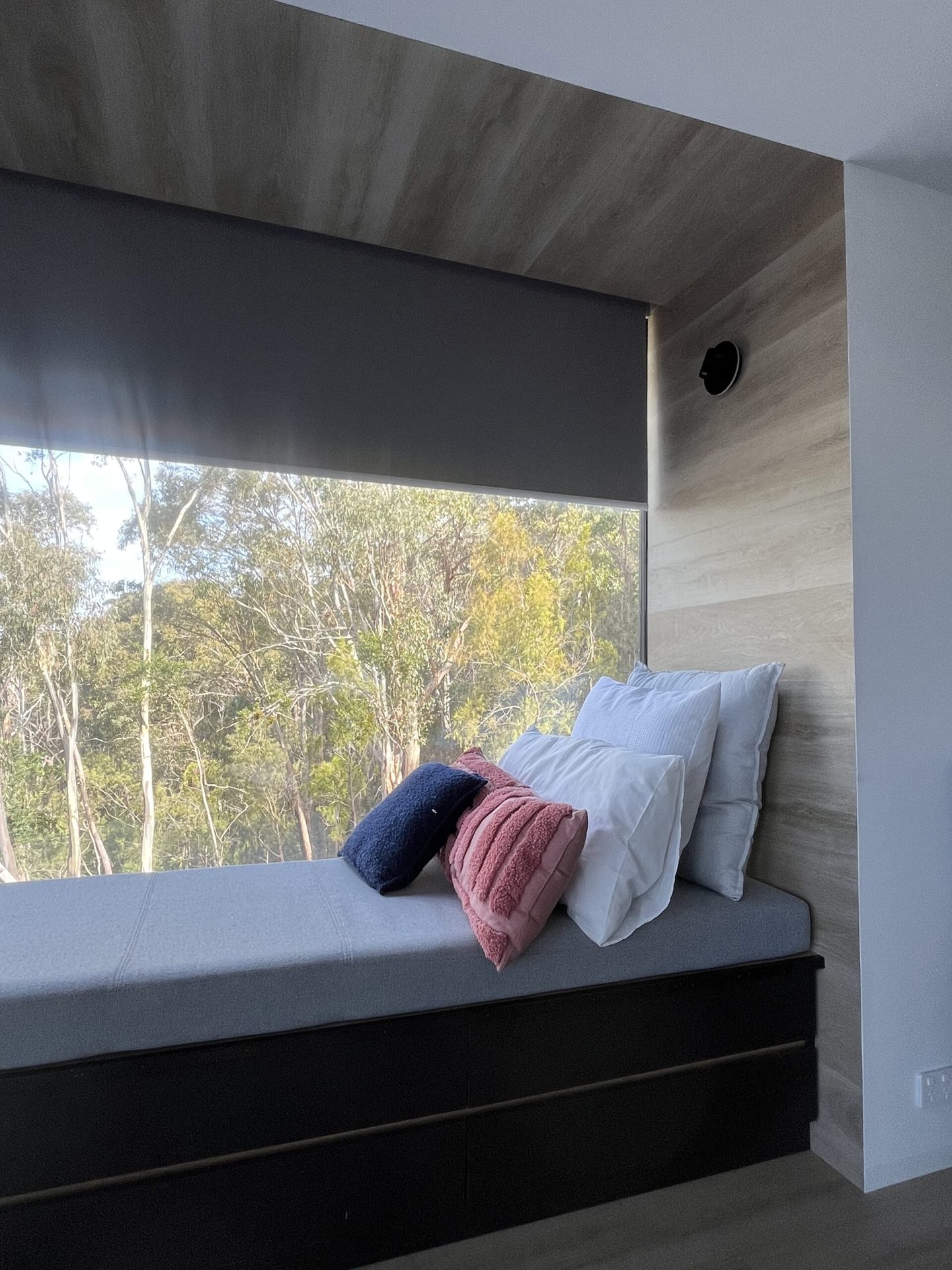 Blockout roller blind lowered above a built in window seat