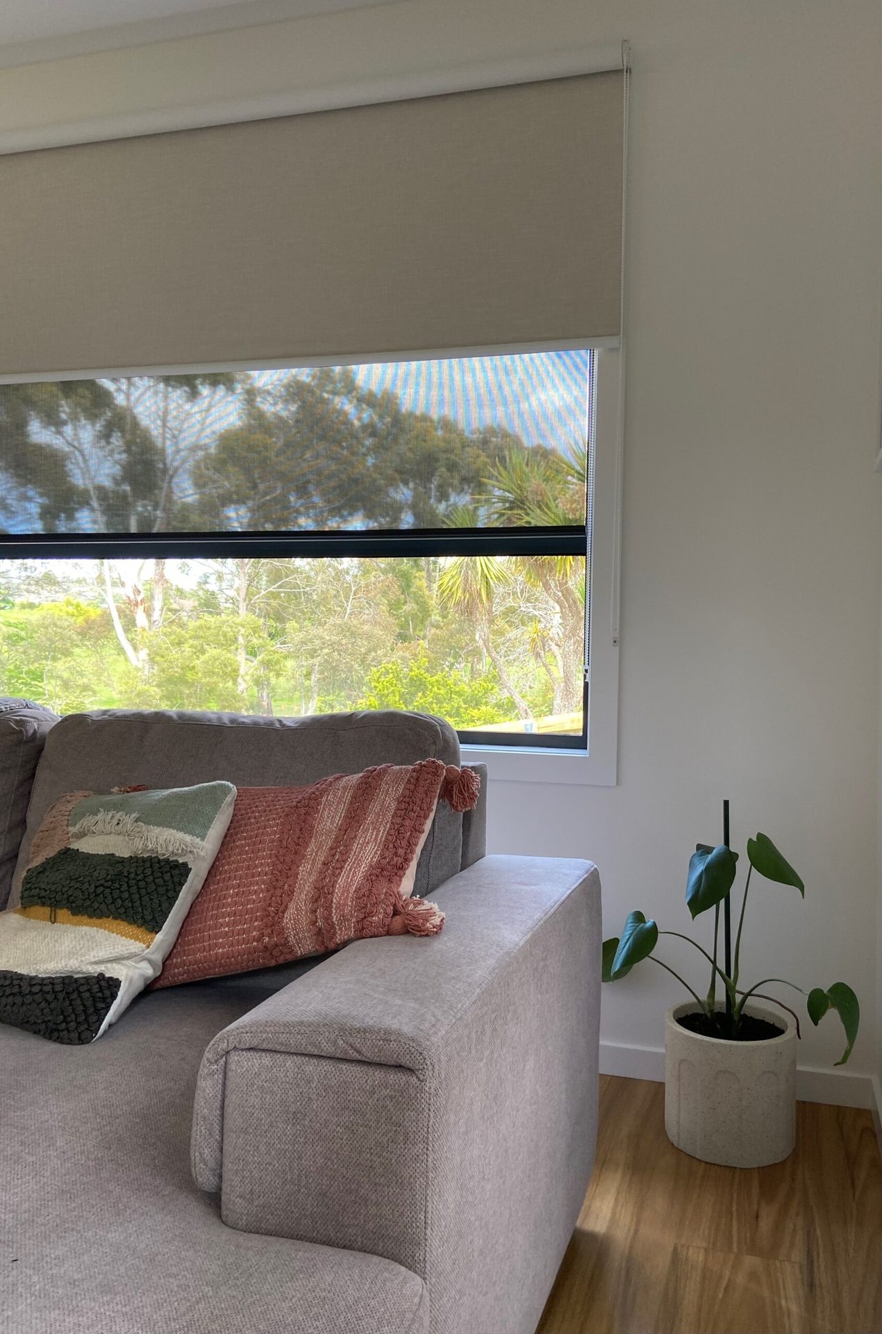Dual roller blinds fitted to a tall living room window
